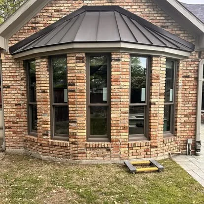 Bay window installation with metal roof detail