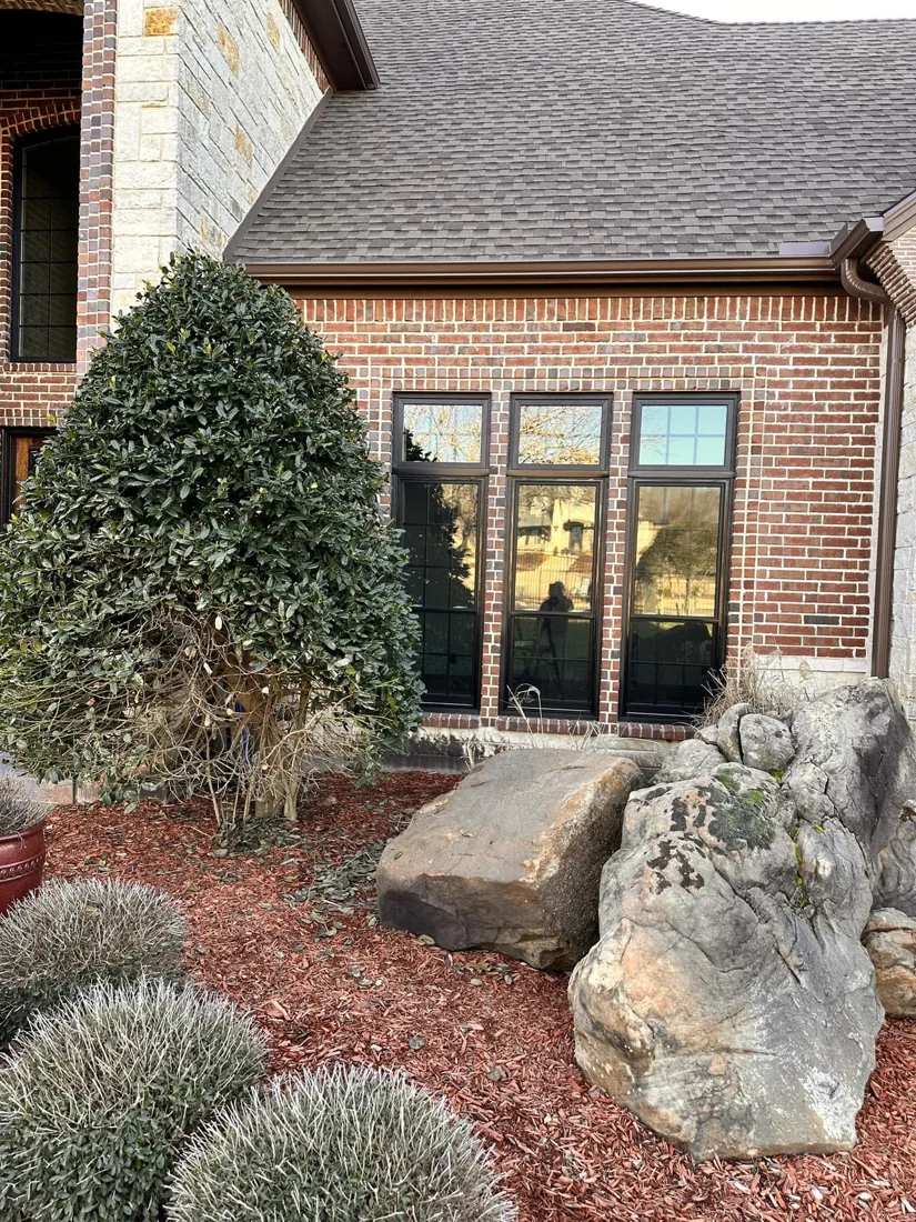 New window installed on a North Texas home with stone landscaping